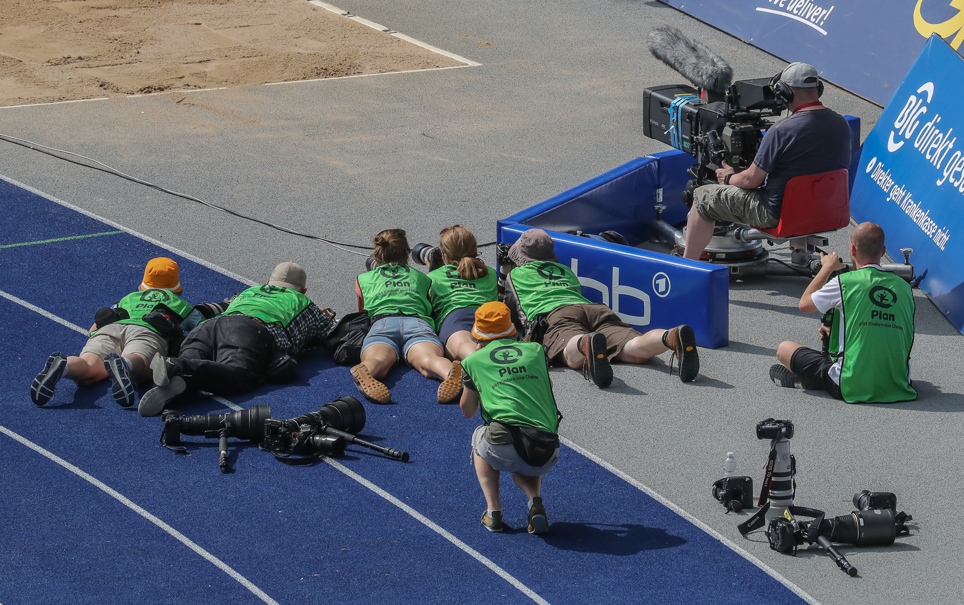 Photographers on ground capturing action shot